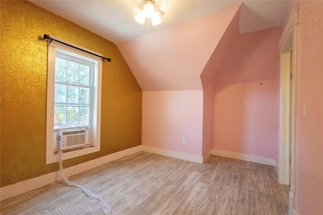 bonus room featuring wood finished floors, vaulted ceiling, cooling unit, ceiling fan, and baseboards