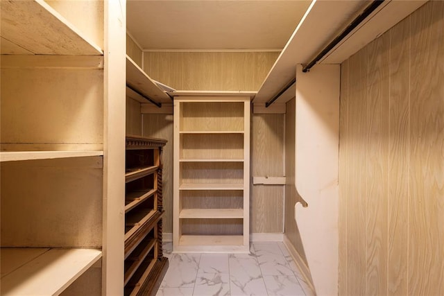 spacious closet with marble finish flooring