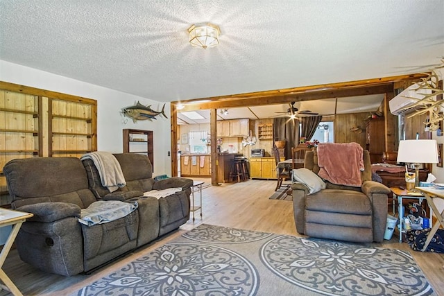 114166 S 4209th Rd, Eufaula, OK 74432 - living area featuring light wood-style flooring, a textured ceiling, wood walls, and ceiling fan