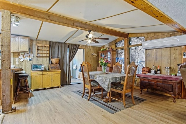 114166 S 4209th Rd, Eufaula, OK 74432 - dining space with wooden walls, light wood-type flooring, ceiling fan, a wall mounted air conditioner, and plenty of natural light