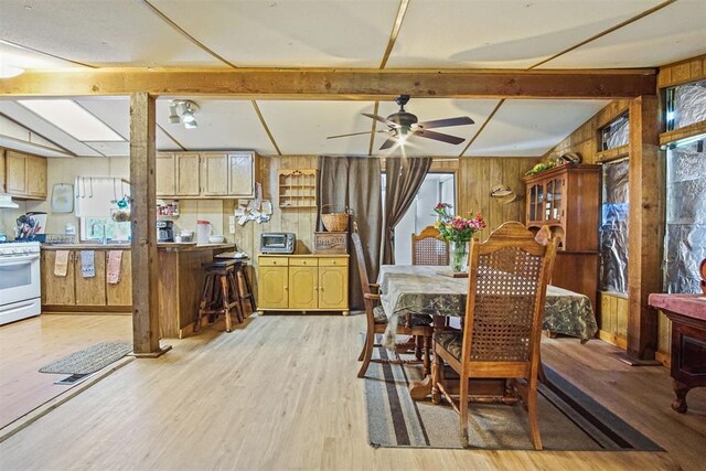 114166 S 4209th Rd, Eufaula, OK 74432 - dining room with wood walls, light wood-style floors, ceiling fan, and healthy amount of natural light