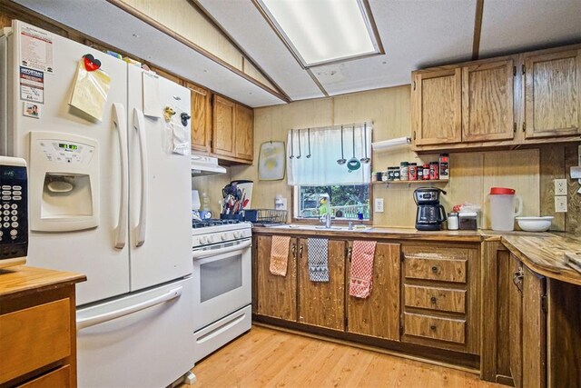 114166 S 4209th Rd, Eufaula, OK 74432 - kitchen with white appliances, a sink, light wood finished floors, brown cabinets, and under cabinet range hood
