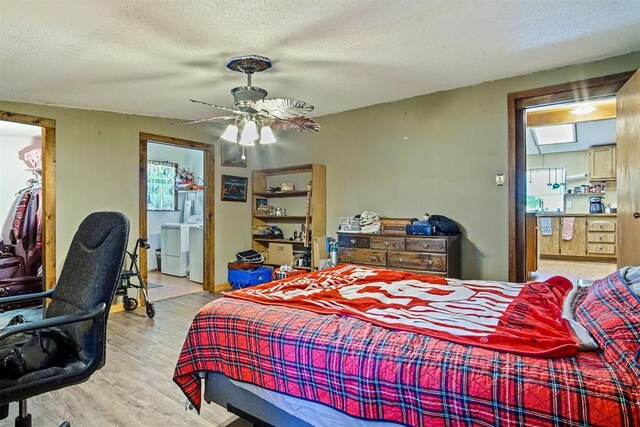 114166 S 4209th Rd, Eufaula, OK 74432 - bedroom with wood finished floors, washer and dryer, a textured ceiling, ensuite bathroom, and ceiling fan