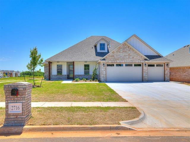2716 Dunham Dr, Norman, OK 73071 - view of front of house featuring board and batten siding, an attached garage, a front lawn, concrete driveway, and a shingled roof