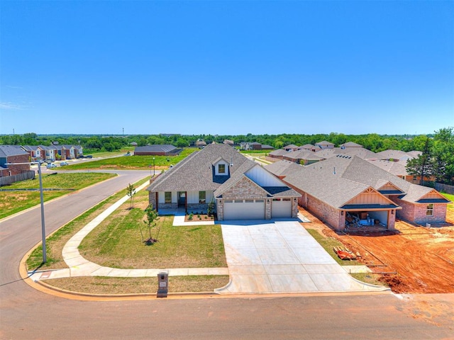 2716 Dunham Dr, Norman, OK 73071 - view of front facade featuring a garage, concrete driveway, brick siding, and a residential view