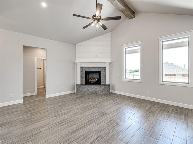 2716 Dunham Dr, Norman, OK 73071 - unfurnished living room featuring a ceiling fan, wood finished floors, a stone fireplace, and baseboards