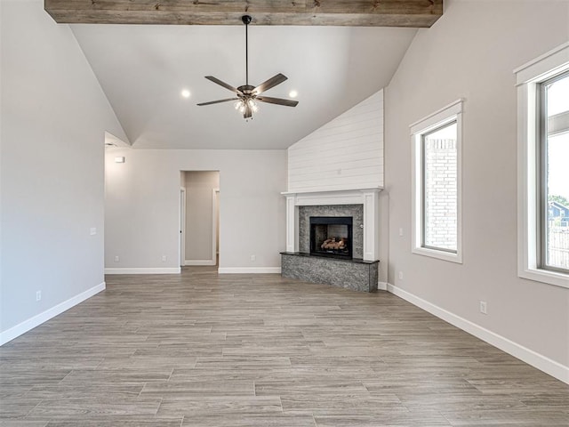 2716 Dunham Dr, Norman, OK 73071 - unfurnished living room featuring a ceiling fan, high vaulted ceiling, plenty of natural light, light wood-style flooring, and a premium fireplace