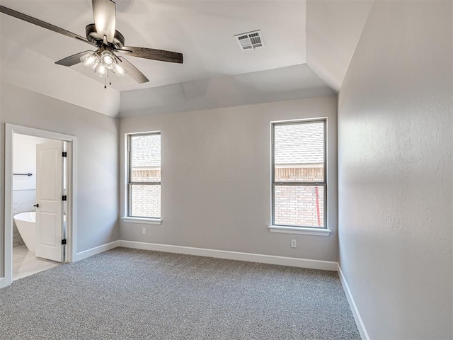 2716 Dunham Dr, Norman, OK 73071 - unfurnished bedroom with multiple windows, baseboards, light colored carpet, and vaulted ceiling