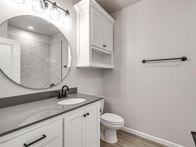 2716 Dunham Dr, Norman, OK 73071 - bathroom featuring wood finished floors, vanity, toilet, baseboards, and a shower