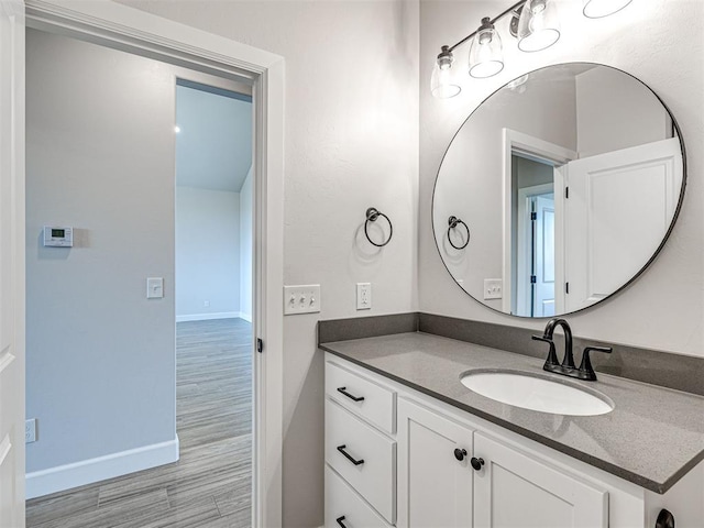2716 Dunham Dr, Norman, OK 73071 - bathroom featuring wood finished floors, vanity, and baseboards
