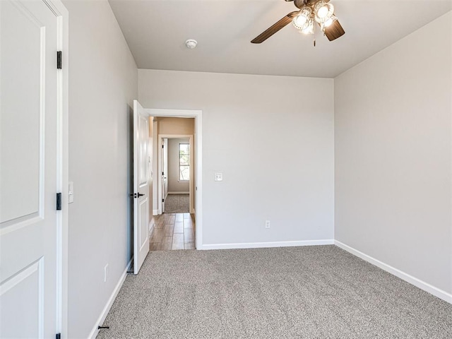 2716 Dunham Dr, Norman, OK 73071 - unfurnished bedroom featuring light colored carpet, baseboards, and a ceiling fan