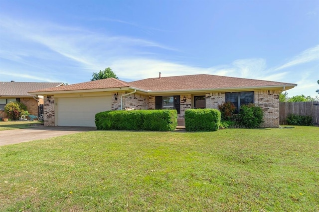 2613 SW 95th St, Oklahoma City, OK 73159 - ranch-style house featuring a garage, brick siding, and concrete driveway