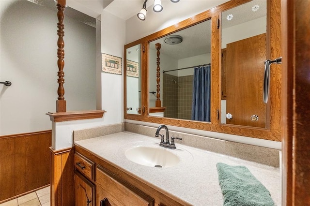 2613 SW 95th St, Oklahoma City, OK 73159 - full bathroom featuring wainscoting, vanity, a shower with curtain, wood walls, and tile patterned flooring