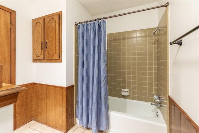 2613 SW 95th St, Oklahoma City, OK 73159 - bathroom featuring a wainscoted wall and shower / bathtub combination with curtain