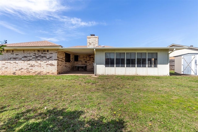 2613 SW 95th St, Oklahoma City, OK 73159 - back of house featuring a storage unit, a chimney, a lawn, and a patio