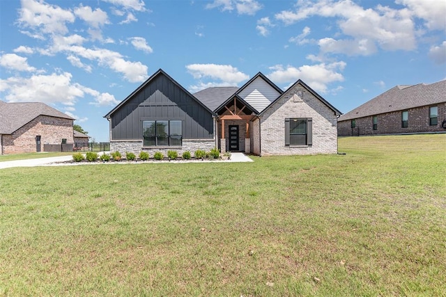 2246 Jackson Ln, Blanchard, OK 73010 - view of front facade featuring board and batten siding, a front yard, and stone siding