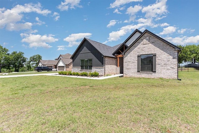 2246 Jackson Ln, Blanchard, OK 73010 - view of front facade with board and batten siding and concrete driveway