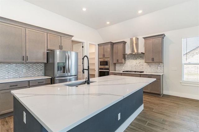 2246 Jackson Ln, Blanchard, OK 73010 - kitchen featuring wall chimney exhaust hood, stainless steel appliances, a sink, baseboards, and decorative backsplash