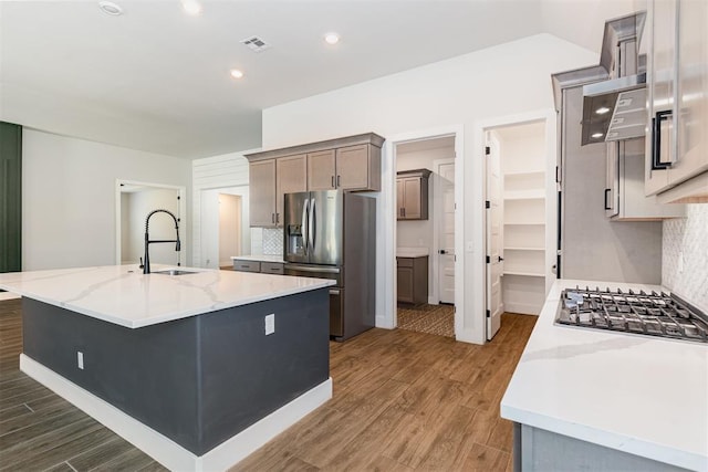 2246 Jackson Ln, Blanchard, OK 73010 - kitchen featuring stainless steel appliances, a sink, tasteful backsplash, wood finished floors, and recessed lighting
