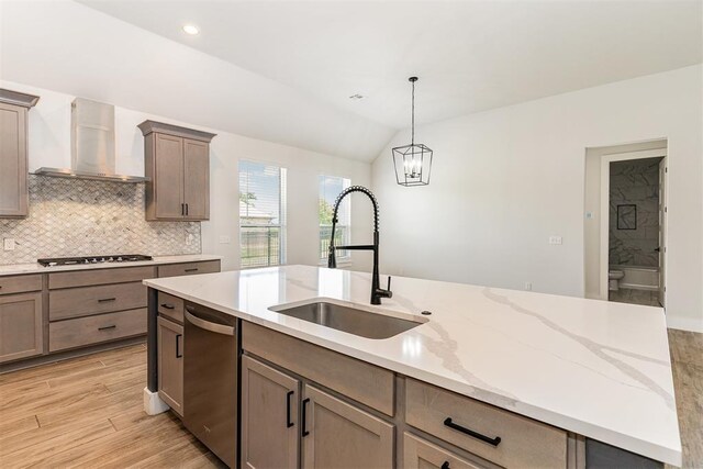 2246 Jackson Ln, Blanchard, OK 73010 - kitchen featuring wall chimney exhaust hood, stainless steel appliances, a sink, vaulted ceiling, and backsplash
