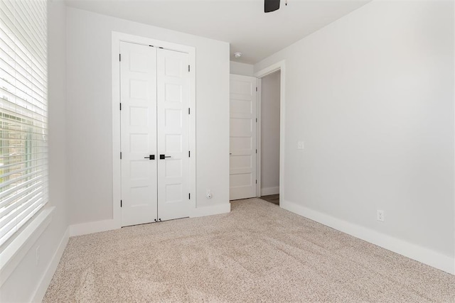 2246 Jackson Ln, Blanchard, OK 73010 - unfurnished bedroom featuring carpet flooring, a closet, baseboards, and ceiling fan