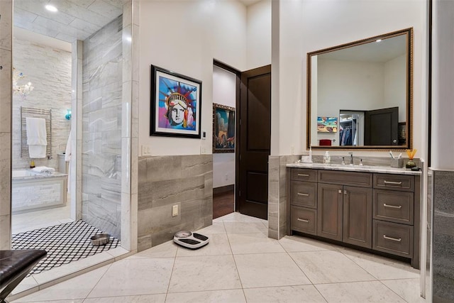 4400 NW 150th St, Oklahoma City, OK 73134 - full bath with vanity, tiled shower, a wainscoted wall, tile walls, and tile patterned floors