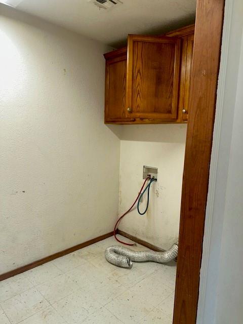 116 N Mahan St, El Reno, OK 73036 - laundry area with cabinet space, tile patterned floors, and washer hookup