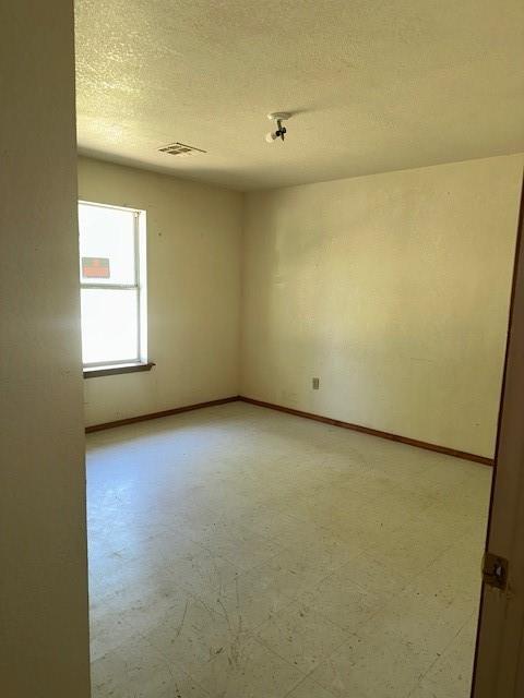 116 N Mahan St, El Reno, OK 73036 - spare room with light flooring and a textured ceiling