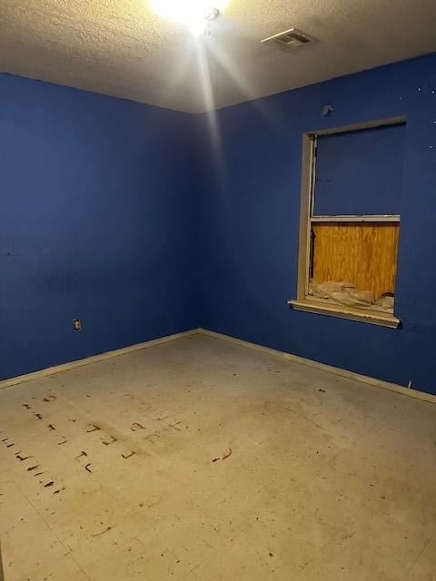 116 N Mahan St, El Reno, OK 73036 - unfurnished room with a textured ceiling and baseboards