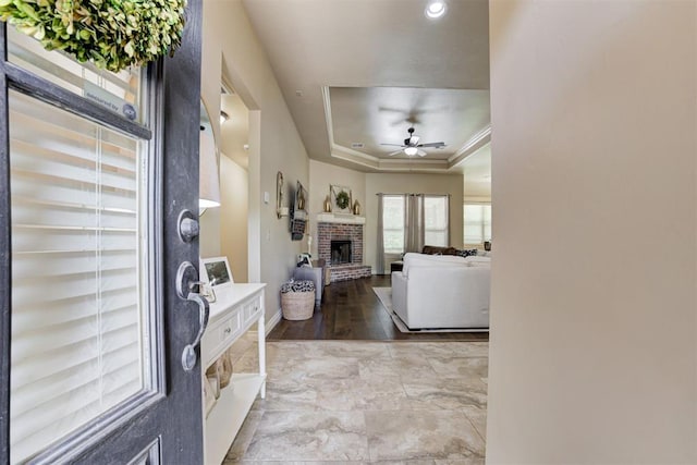 12360 Hidden Run Rd, Guthrie, OK 73044 - entrance foyer with a fireplace, a ceiling fan, a tray ceiling, baseboards, and recessed lighting
