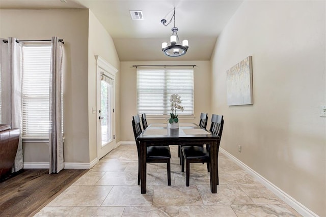 12360 Hidden Run Rd, Guthrie, OK 73044 - dining space featuring a chandelier, vaulted ceiling, and baseboards