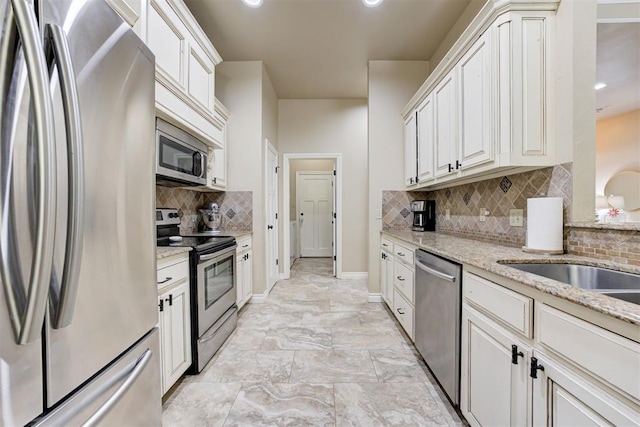 12360 Hidden Run Rd, Guthrie, OK 73044 - kitchen featuring appliances with stainless steel finishes, tasteful backsplash, light stone counters, baseboards, and recessed lighting