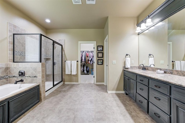 12360 Hidden Run Rd, Guthrie, OK 73044 - full bath featuring a stall shower, vanity, a garden tub, a spacious closet, and tile patterned floors