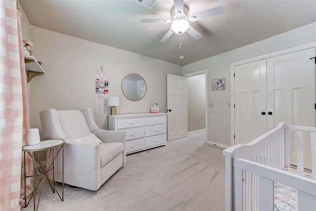 12360 Hidden Run Rd, Guthrie, OK 73044 - bedroom with light carpet, a crib, a closet, a ceiling fan, and baseboards