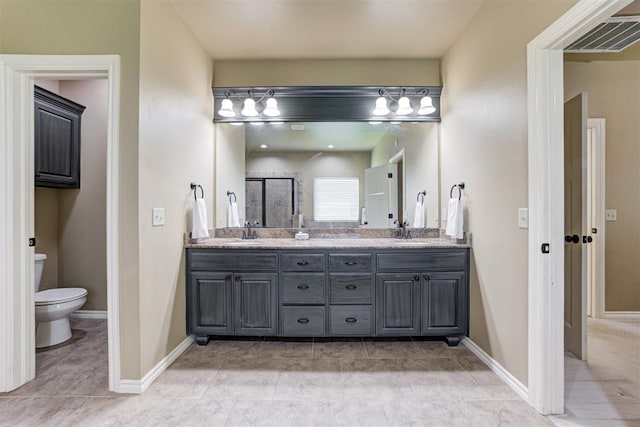 12360 Hidden Run Rd, Guthrie, OK 73044 - bathroom featuring toilet, double vanity, a shower stall, tile patterned floors, and baseboards