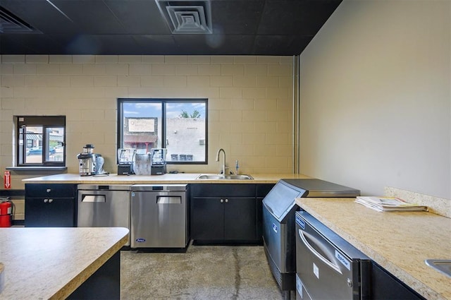 124 N Main St, Broken Bow, OK 74728 - kitchen with a sink, dark cabinets, and light countertops