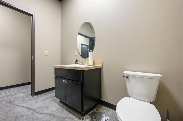 124 N Main St, Broken Bow, OK 74728 - bathroom with vanity, toilet, and baseboards
