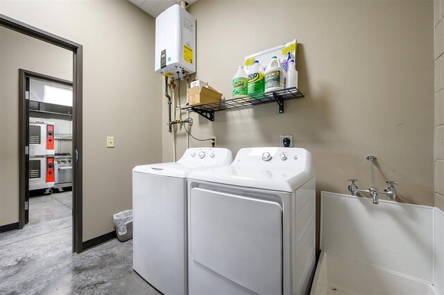 124 N Main St, Broken Bow, OK 74728 - clothes washing area with water heater and independent washer and dryer