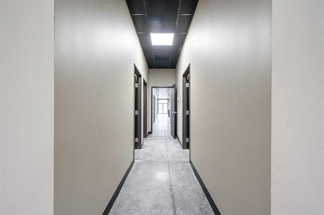 124 N Main St, Broken Bow, OK 74728 - corridor featuring baseboards and concrete flooring
