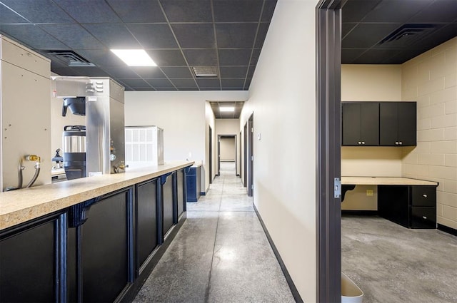 124 N Main St, Broken Bow, OK 74728 - hall featuring a paneled ceiling, concrete flooring, and baseboards
