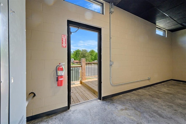 124 N Main St, Broken Bow, OK 74728 - doorway with concrete floors and concrete block wall