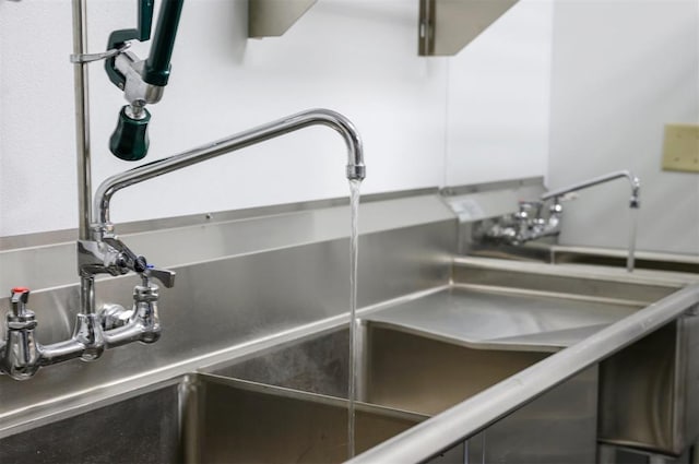 124 N Main St, Broken Bow, OK 74728 - detailed view of pet washing station, white cabinetry, and a sink