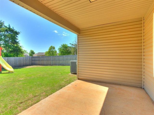 view of yard featuring a patio area, a playground, and central air condition unit