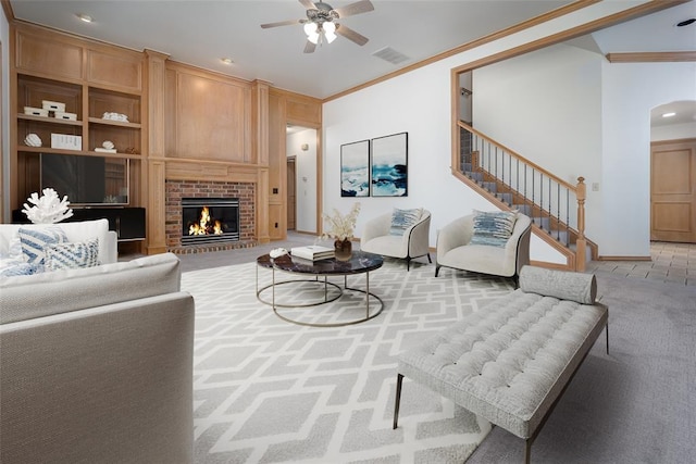 living room featuring ornamental molding, light colored carpet, a ceiling fan, arched walkways, and baseboards