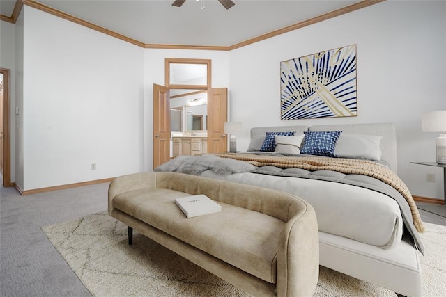 bedroom featuring carpet flooring, crown molding, baseboards, ceiling fan, and connected bathroom