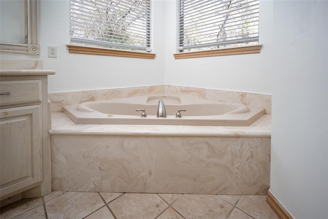 bathroom featuring a bath, tile patterned floors, and vanity