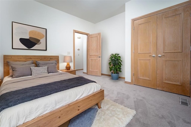bedroom with light carpet and baseboards