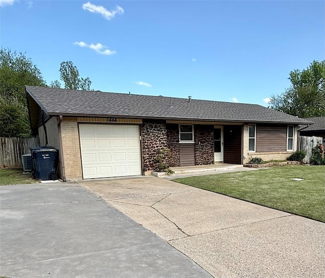 1444 N Bradley Ave, Oklahoma City, OK 73127 - ranch-style home featuring an attached garage, concrete driveway, brick siding, central air condition unit, and a shingled roof