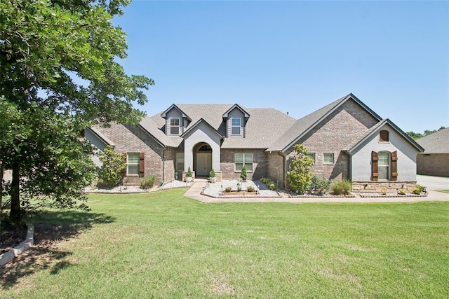 5625 Courtland Ln, Choctaw, OK 73020 - view of front facade with a front yard, stone siding, and brick siding