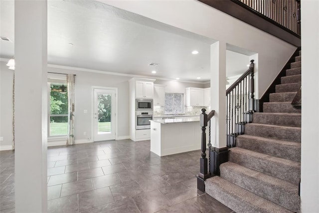 5625 Courtland Ln, Choctaw, OK 73020 - unfurnished living room with stairs, crown molding, baseboards, dark tile patterned floors, and recessed lighting